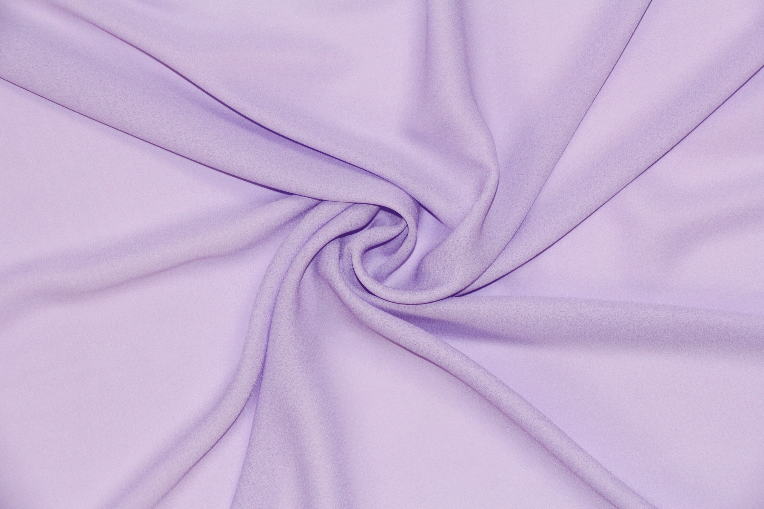 A solid lavender georgette fabric twisted into a spiral.