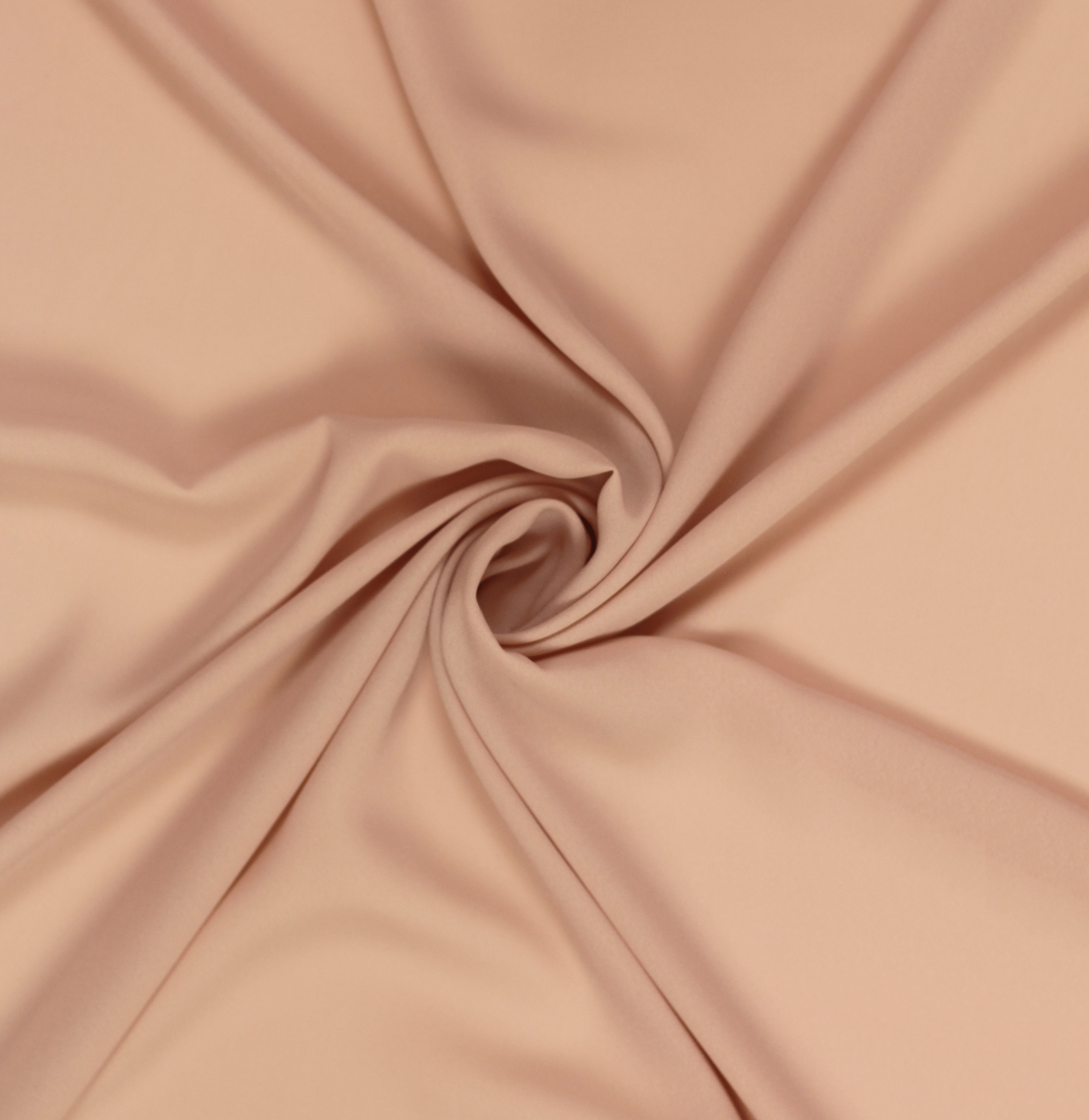 A solid light peach-mauve georgette fabric twisted into a spiral.