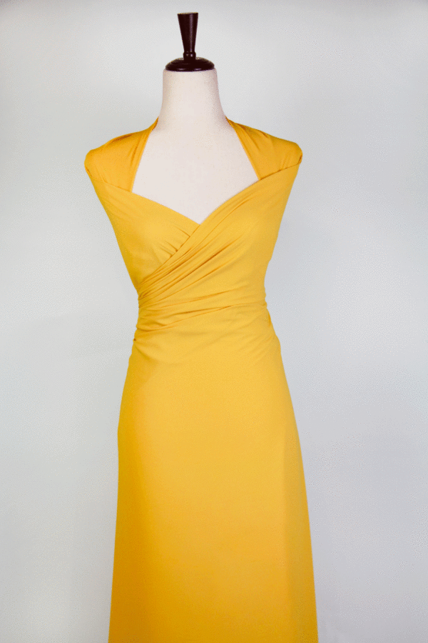 A solid banana yellow georgette fabric wrapped onto a mannequin.