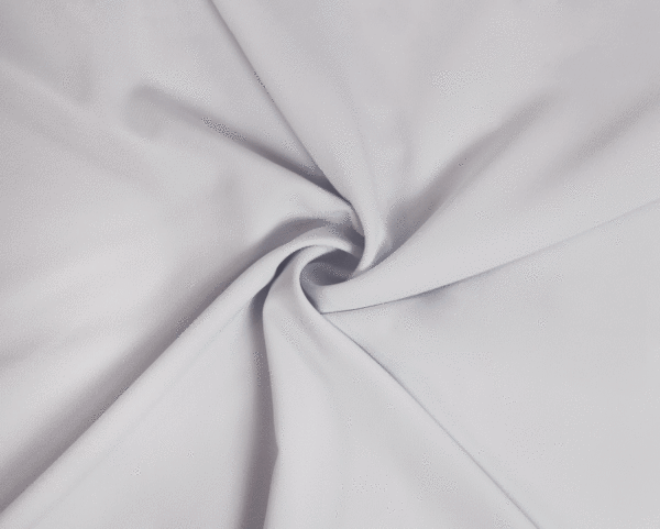 A solid white crepe wool dobby fabric twisted into a spiral.