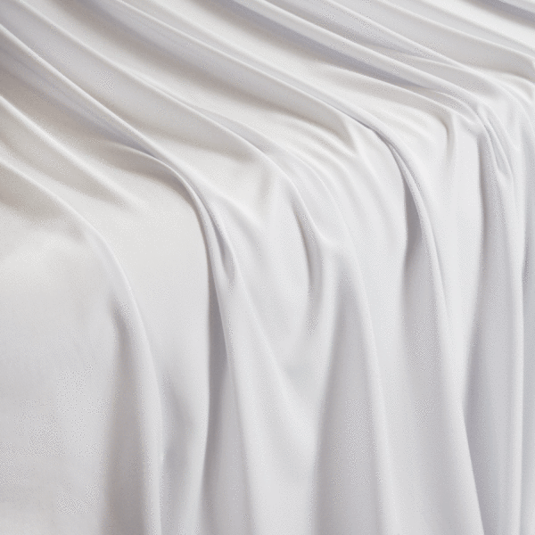A solid white crepe wool dobby fabric flowing over a table in a waterfall pattern.
