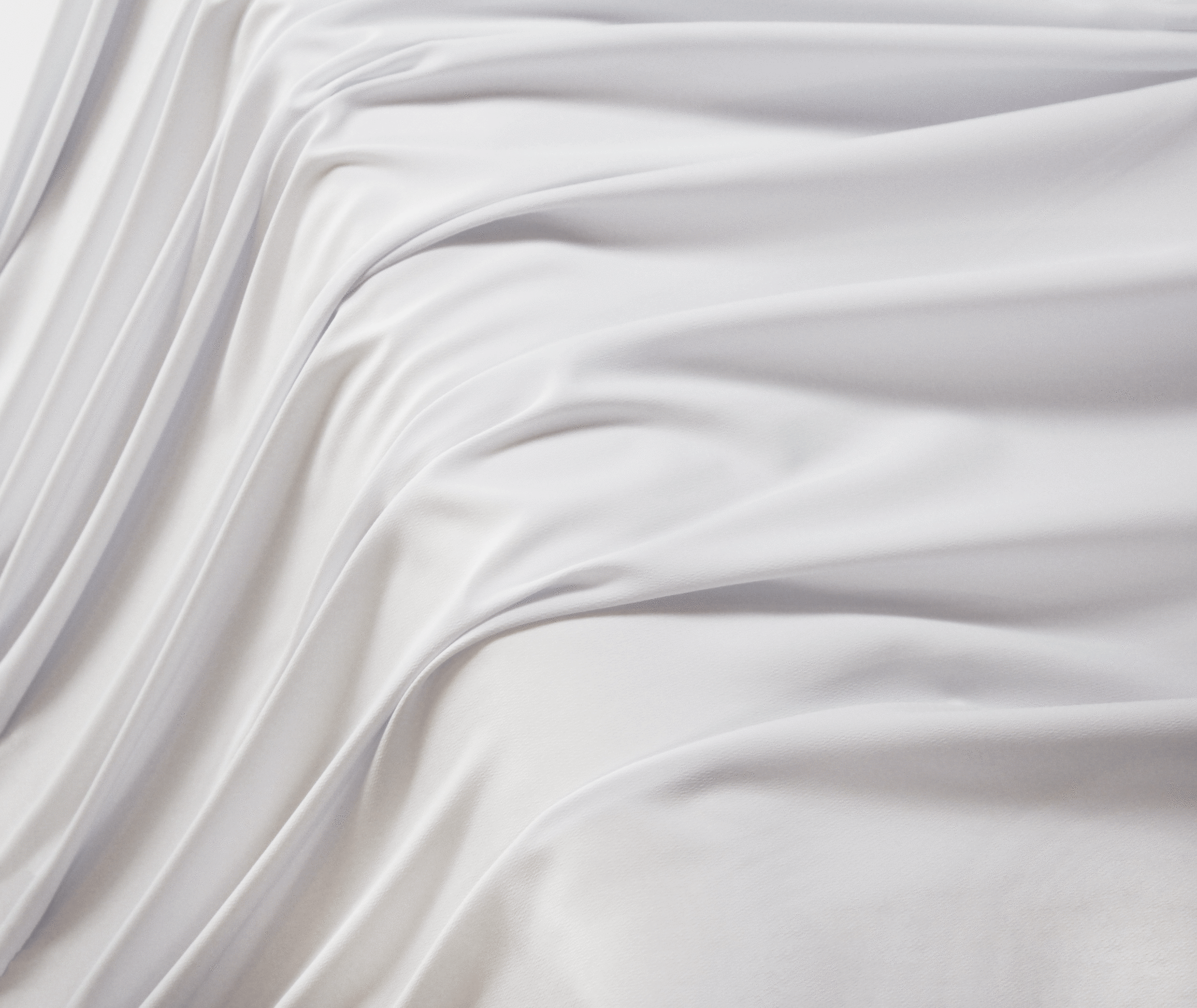 A solid white crepe wool dobby fabric flowing over a table in a waterfall pattern.